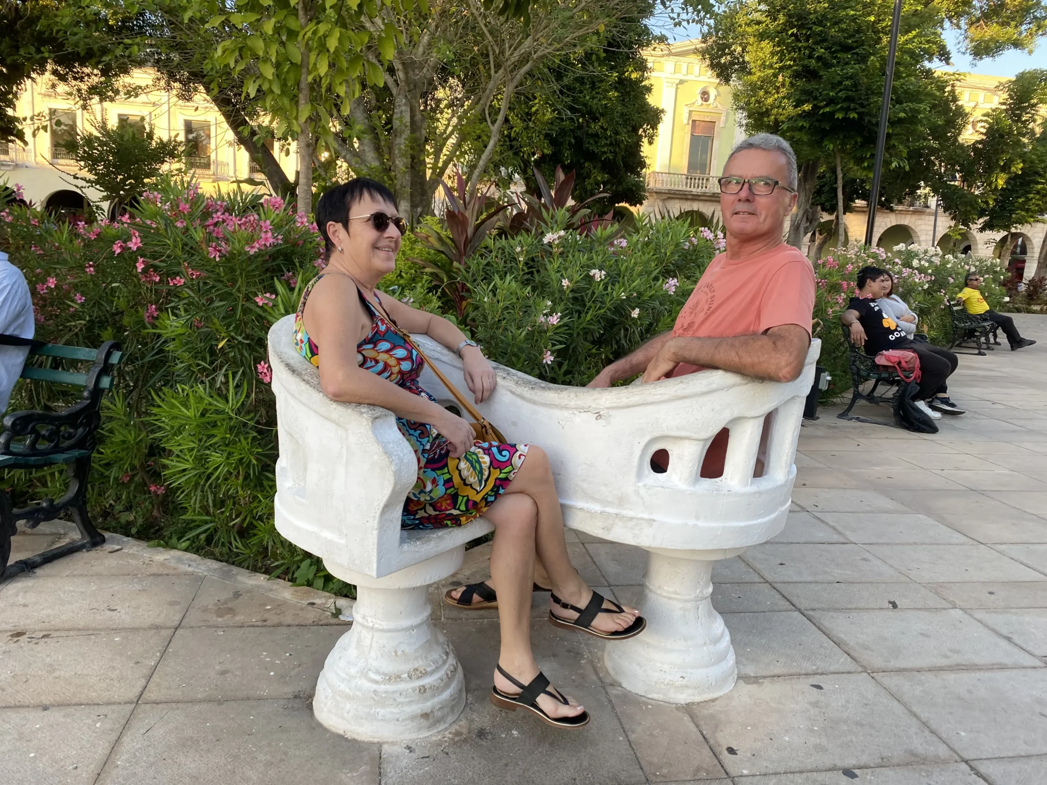 Françoise y Yannick sentados en una silla "tú y yo" en una plaza del centro de Mérida.